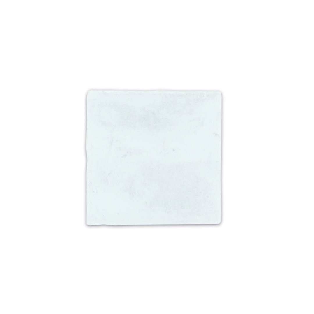 A single 4x4 satin zellige tiles named hearth sky blue. they have a handmade look, textured edge and a pale blue colour variation A single 4x4 satin zellige tiles named hearth sky blue. they have a handmade look, textured edge and a pale blue colour variation