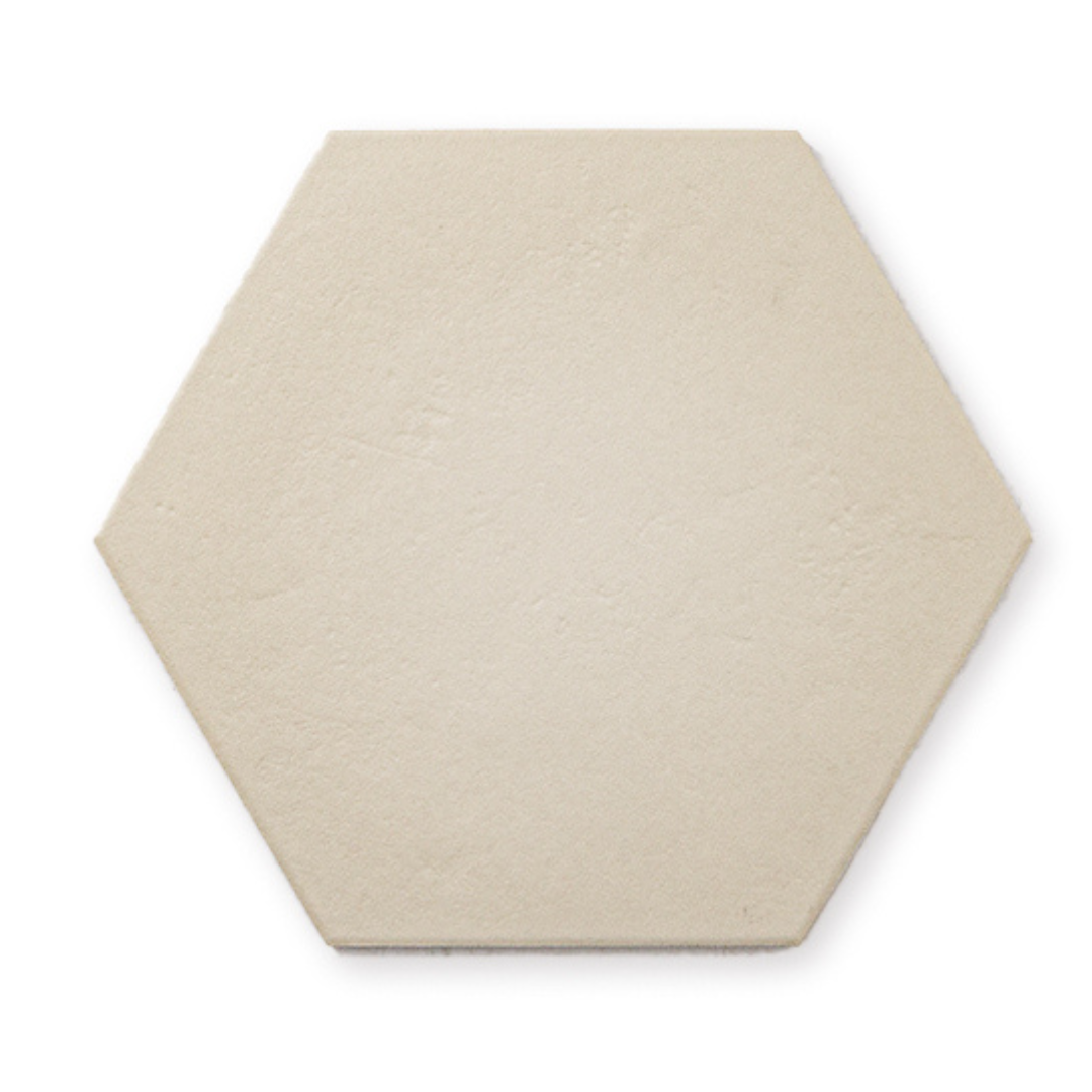 A single 9x10 hexagon tile that is beige with a subtle texture and matte finish. A single 9x10 hexagon tile that is beige with a subtle texture and matte finish.