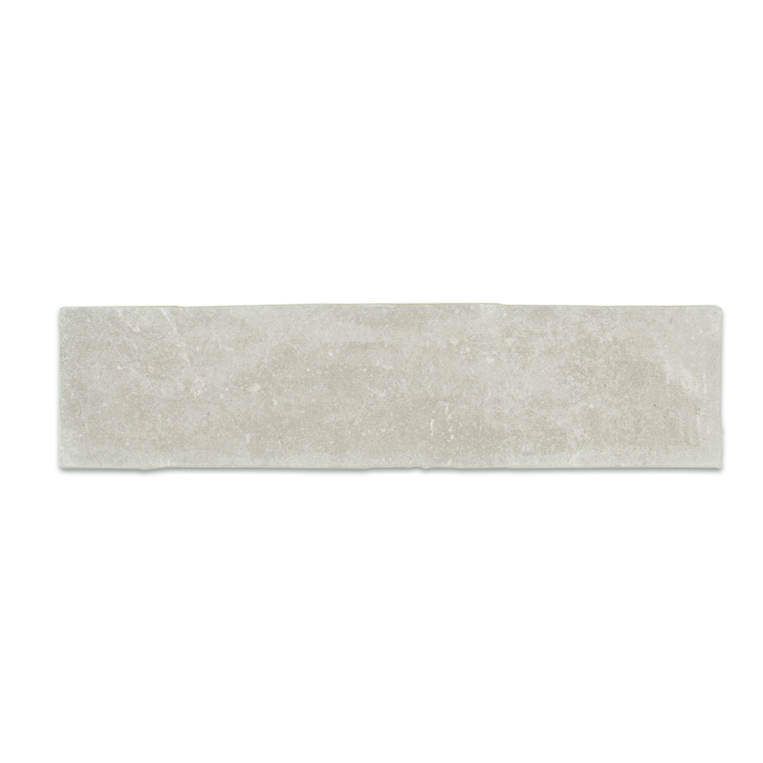 A single 11x2.75 brick clay silver cement grey stone look tile with a natural looking edge and matte finish A single 11x2.75 brick clay silver cement grey stone look tile with a natural looking edge and matte finish