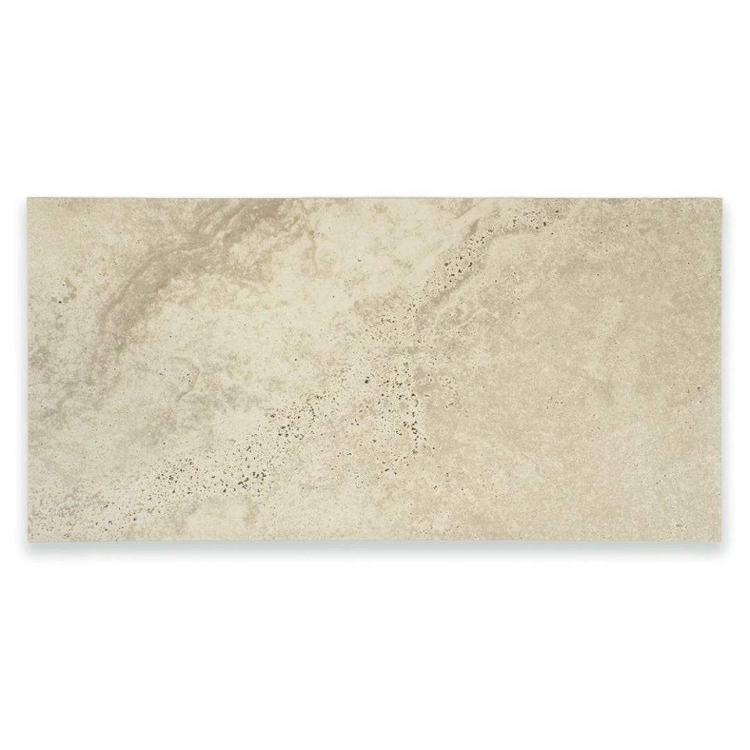 Ariel view of a single large rectangular 12x24 tile that resembles travertine stone in light warm greige. 