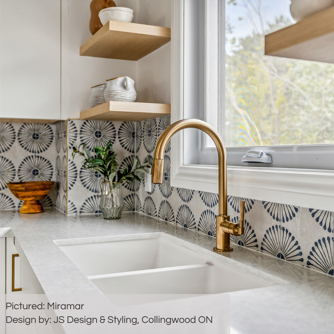 A close up of a modern kitchen backsplash using miramar blue and grey sunburst pattern tiles. 