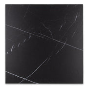 Maison Noir is a black 12x12 matte marble look black tile. perfect for checkerboard applications. his images shows the single tile on it's own with a fine white veining pattern across the rich black tile. 