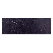 A single 5x16 stone look black tile with white speckling. 