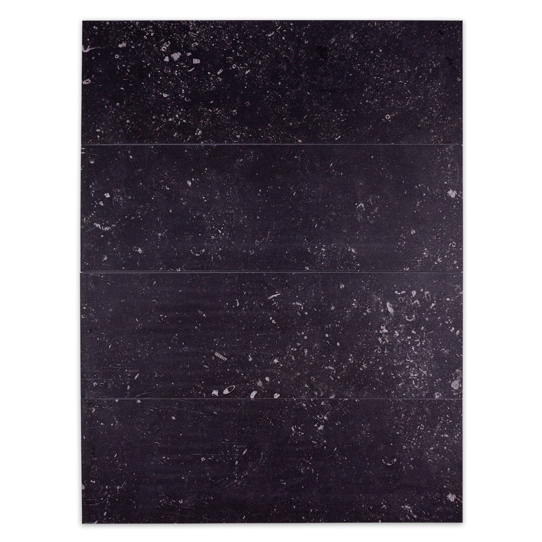 Ariel view of four 5x16 stone look black tiles with white speckling stacked together to show the random pattern. 