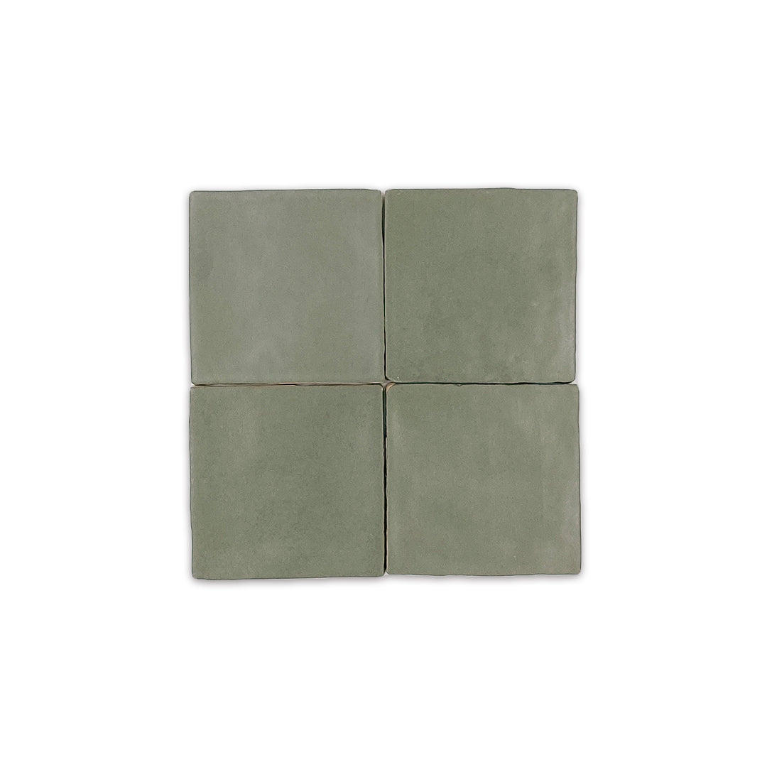 A group of four 4x4 satin zellige tiles named hearth olive green. they have a handmade look a subtle colour variation
