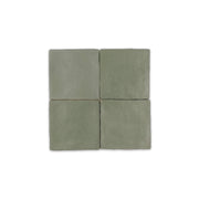A group of four 4x4 satin zellige tiles named hearth olive green. they have a handmade look a subtle colour variation