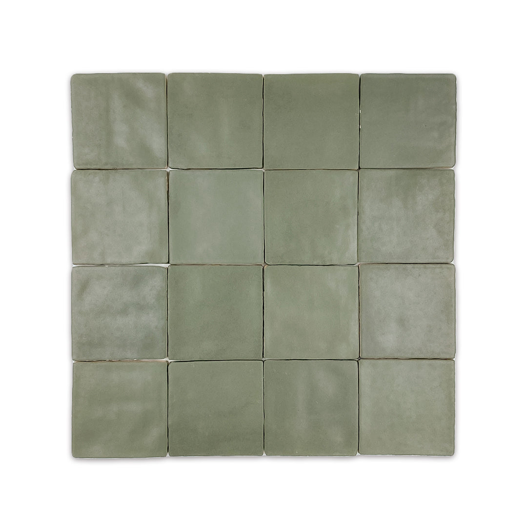 A group of 4x4 satin zellige tiles named hearth olive green. they have a handmade look, textured edge and a subtle colour variation