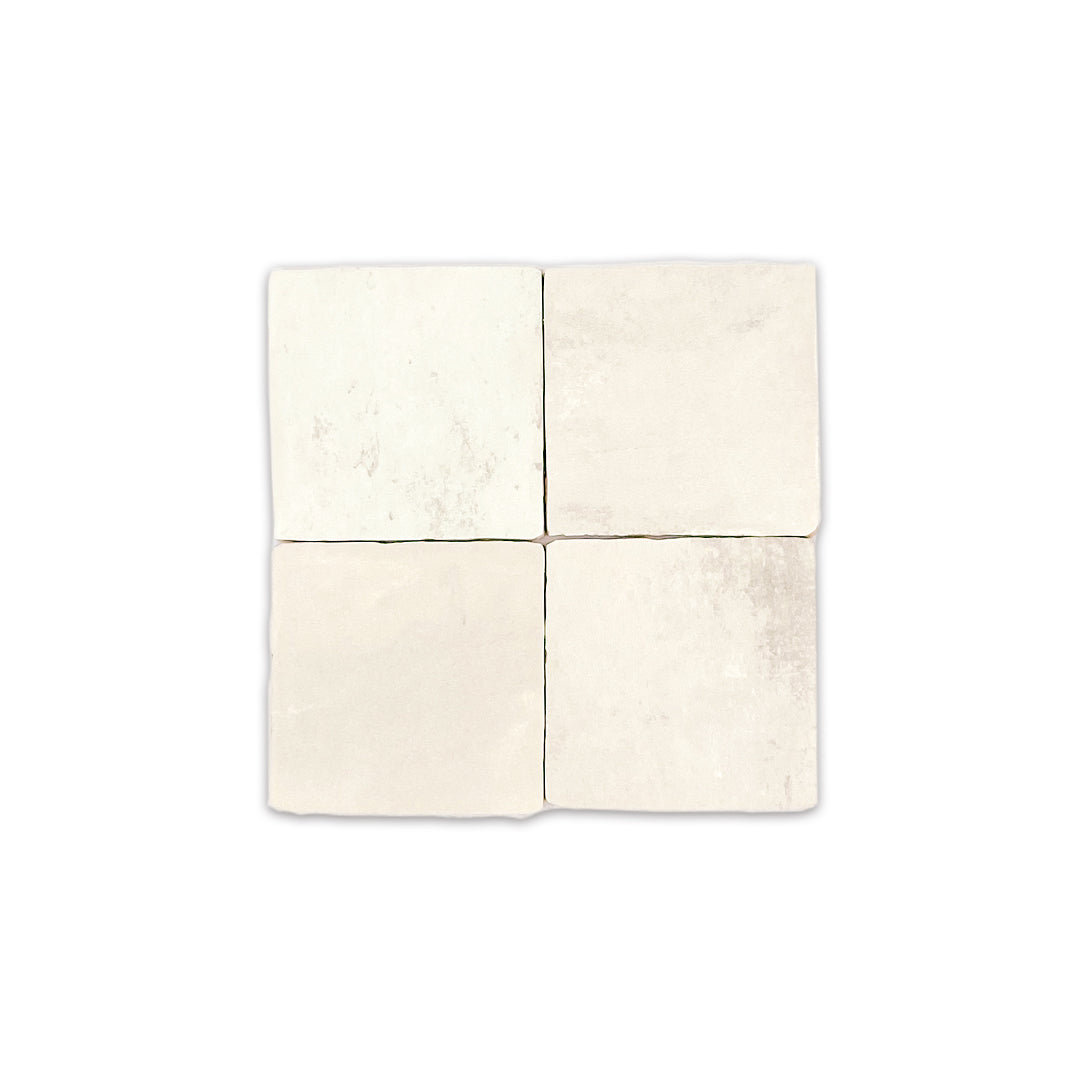 A group of four 4x4 satin zellige tiles named plaster off white. they have a handmade look a subtle colour variation