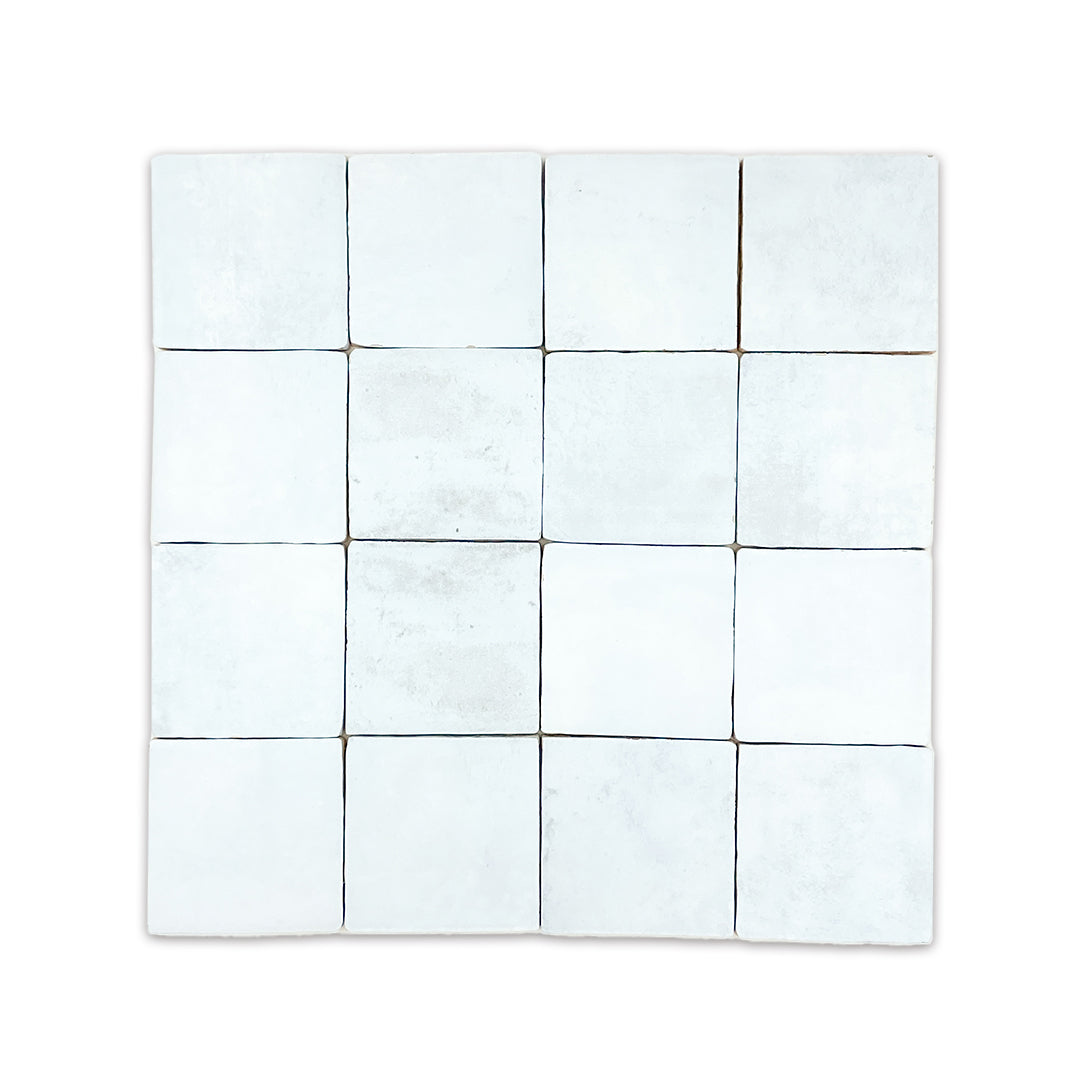 ariel view of a group of 4x4 satin zellige tiles named hearth sky blue. they have a handmade look, textured edge and a pale blue colour variation