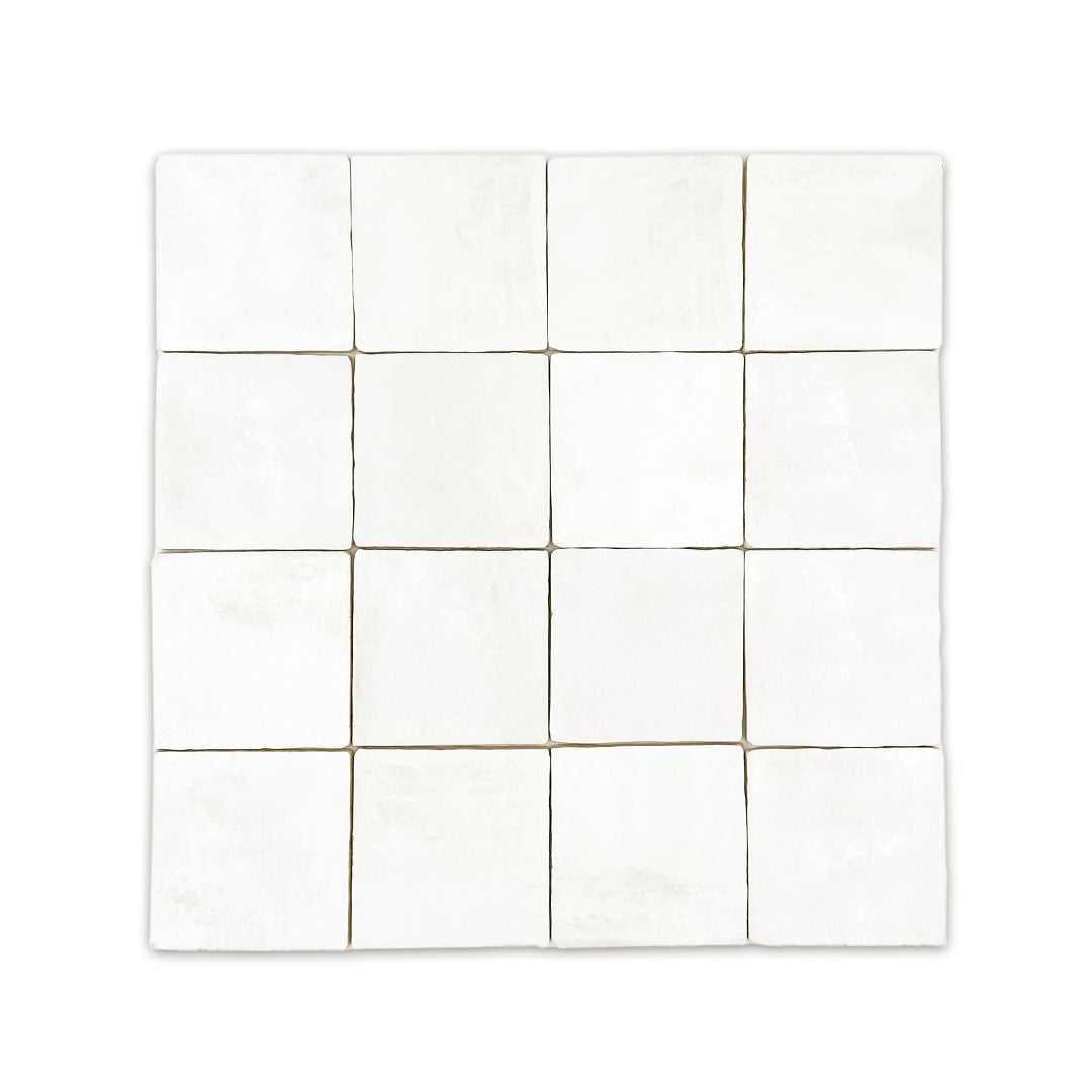 Ariel view of a group of 4x4 satin zellige tiles named white. they have a handmade look, textured uneven edges and a subtle colour variation