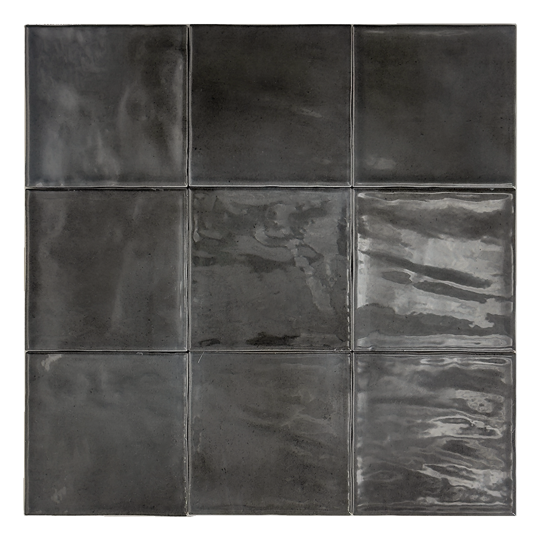 Ariel view of a group of nine glossy 4x4 black tiles. Highlighting the slight colour variations, texture and finish.
