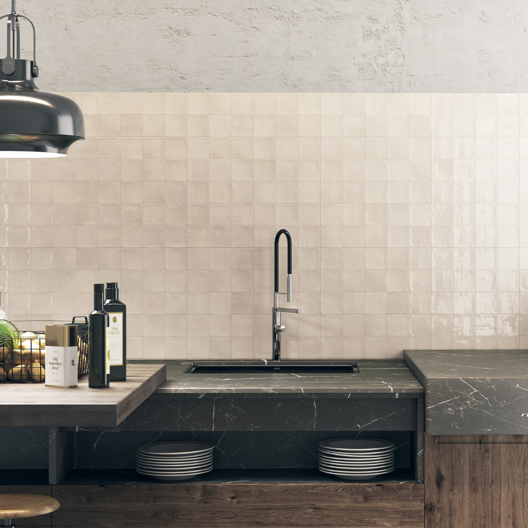 A modern vignette of a tiled backsplash kitchen wall and modern black and wood finishes. The tile on the wall is 4x4 glossy ivory tiles that have textured edges, a slight colour variance and a shiny finish that catches the light. 