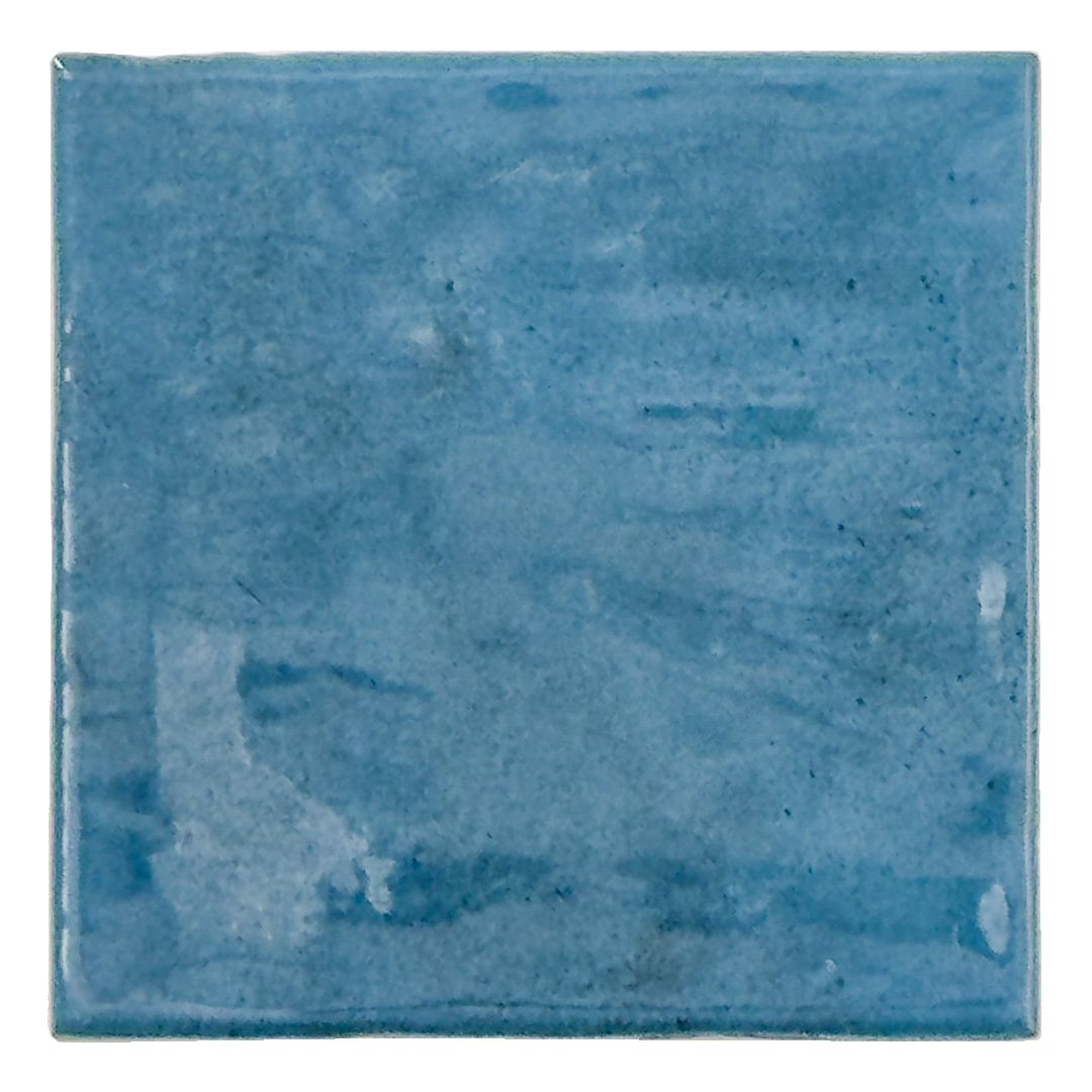 Ariel view of a single sapphire blue 4x4 glossy tile with textured edges and a handmade hand painted look. 