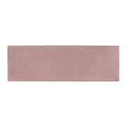 A single 2x6.5 glossy pink subway tile. 