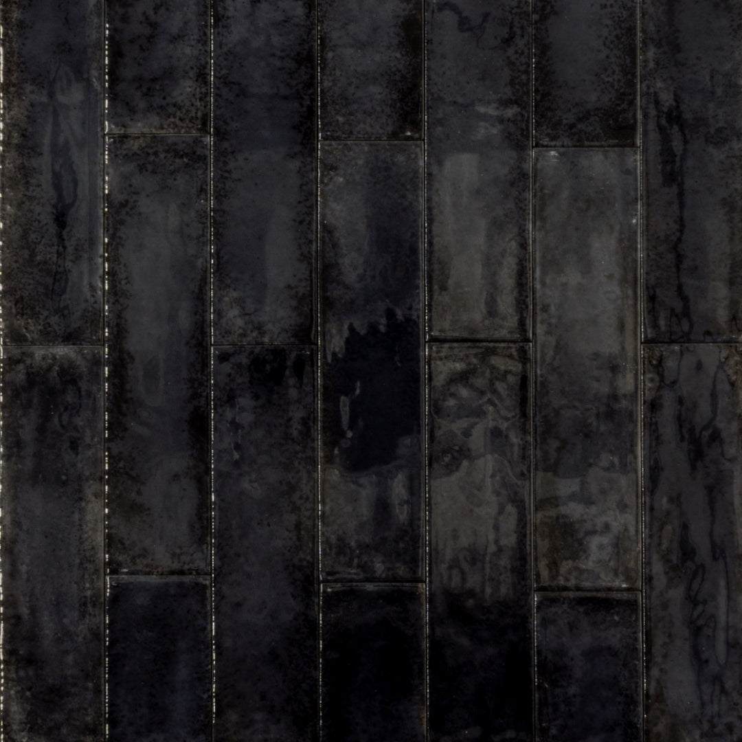 Ariel view of 2x9 black glossy tiles in a brick layout with colour variation