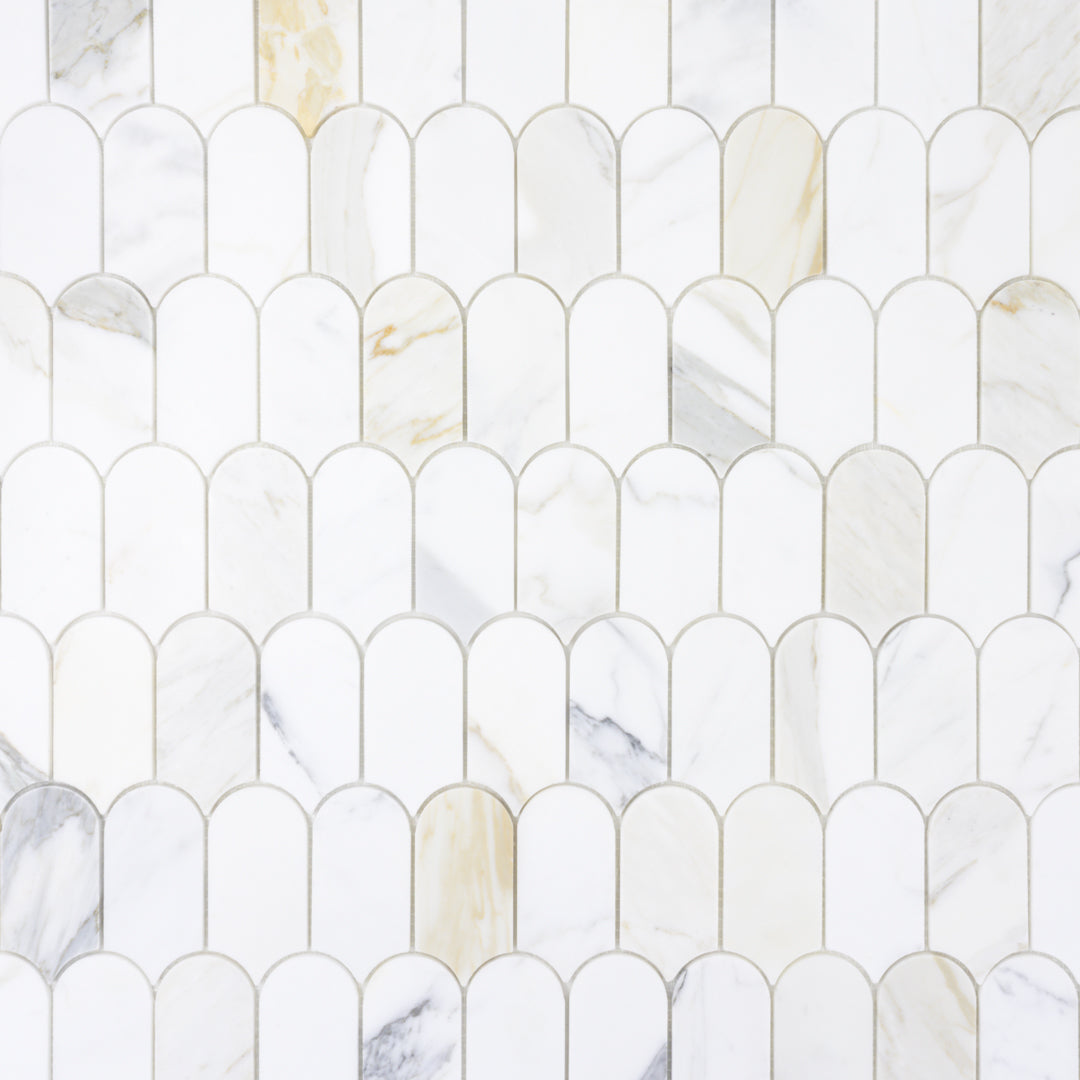 ariel view of a natural marble stone mosaic in calacatta matte 2x4 feather scallop rounded arched pieces.