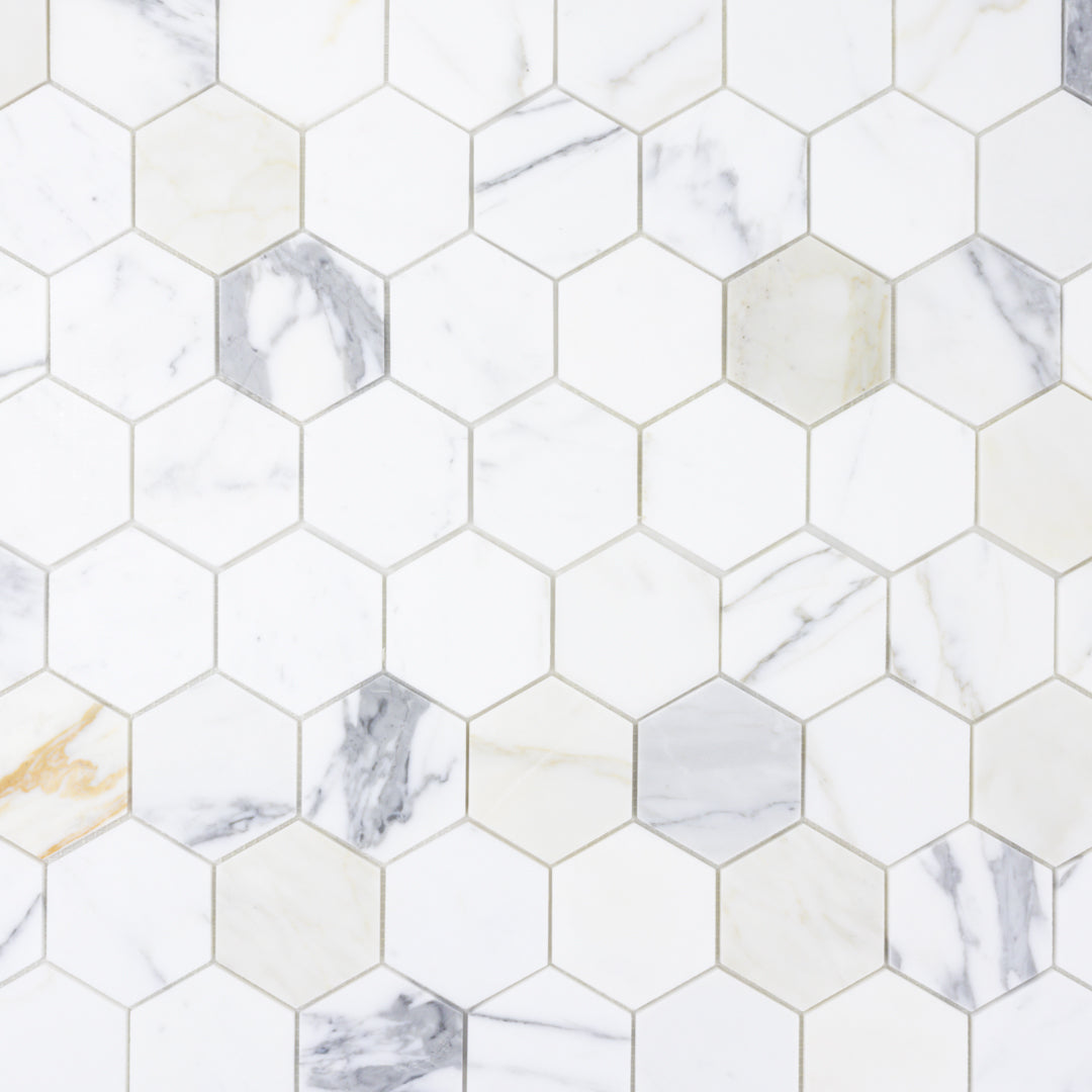 a close up of a sheet of matte calacatta 3" hexagon mosaic