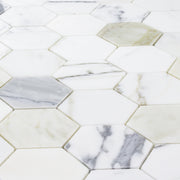 a close up of a sheet of matte calacatta 3" hexagon mosaic