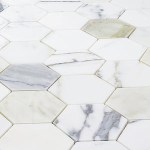 a close up of a sheet of matte calacatta 3" hexagon mosaic