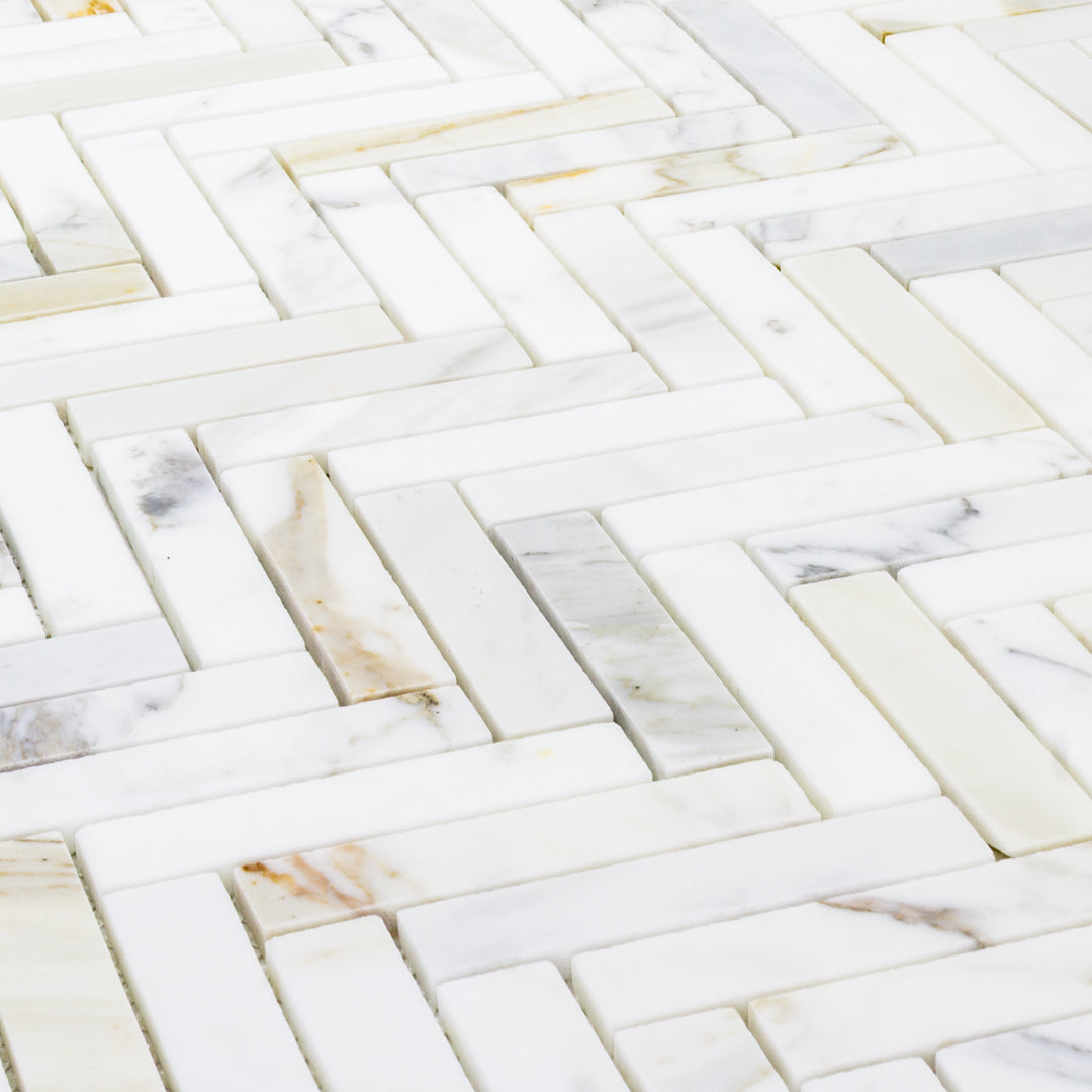 close up of calacatta natural stone herringbone mosaic. 