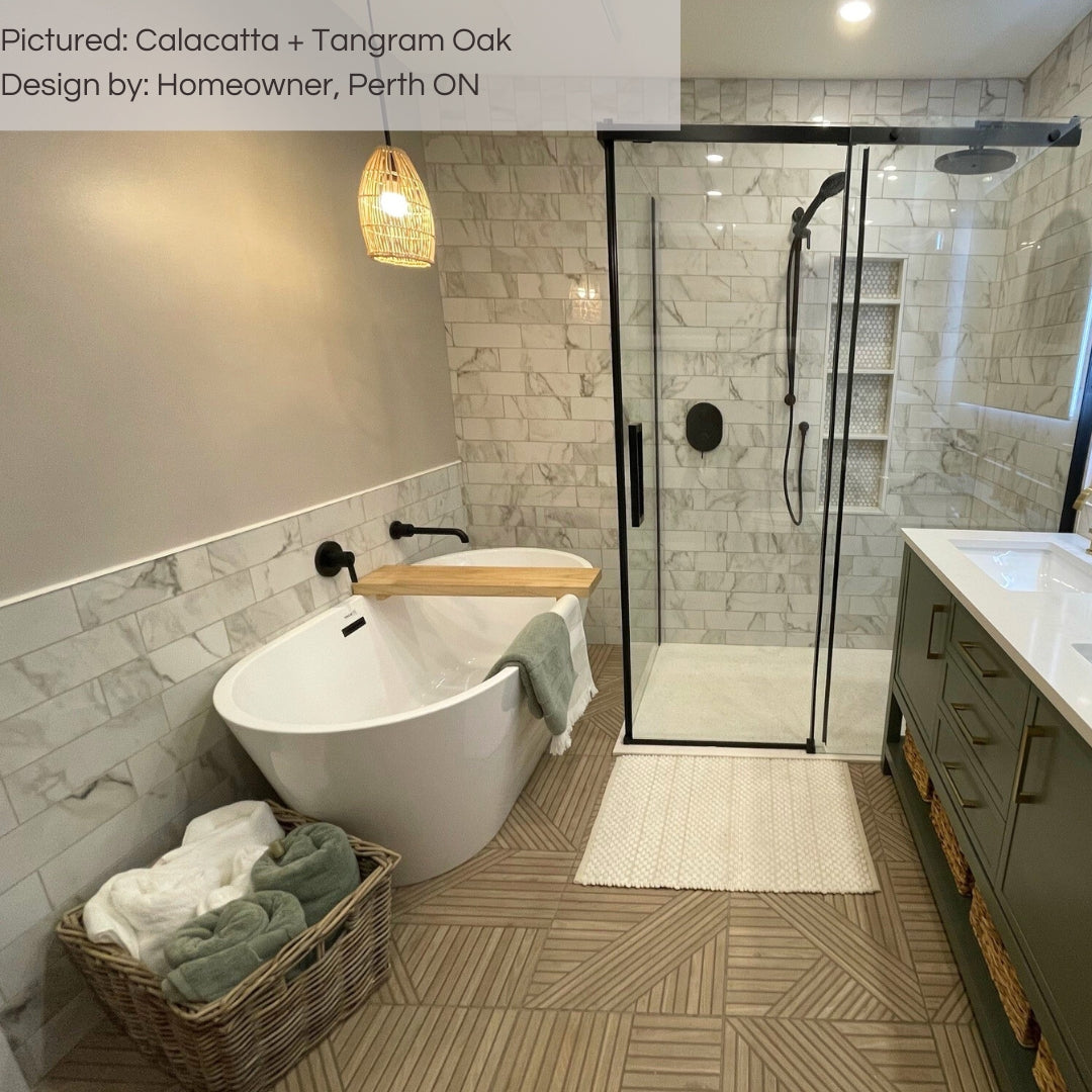 A modern bathroom with Calacatta 4x12 subway tiles on the shower walls and tangroam oak wood look geometric tiles on the floor.  the warm tones in the faux marble compliments the tangram oak. 
