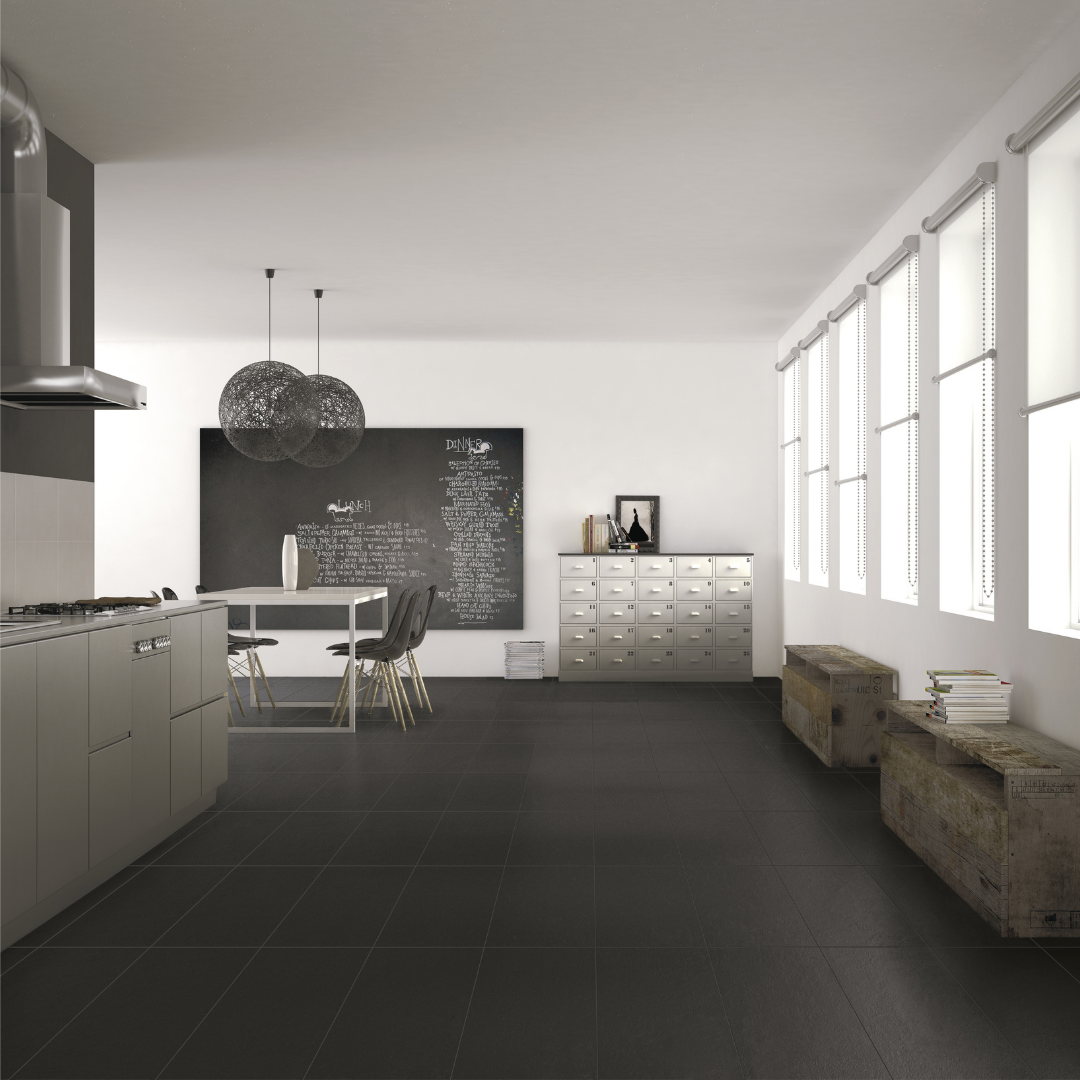 An open concept black and white kitchen dining room featuring Checkmate Black 12x24 on the floors. 