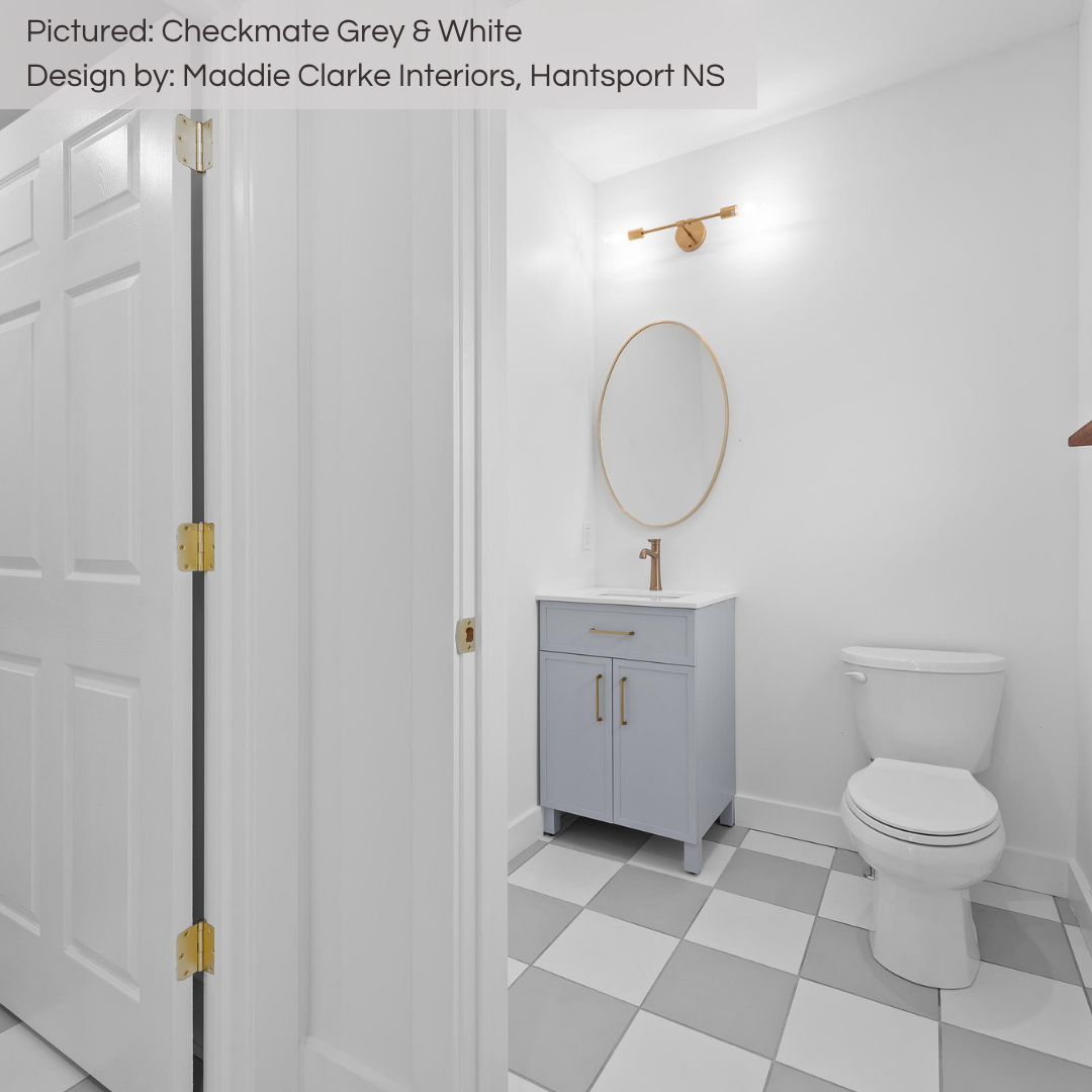 A bright, pretty and neutral white powder room with a grey sink vanity. The floors infuse some fun in the design with a mix of grey and white 12x12 floor tiles installed checker board style. A timeless look for years to come!