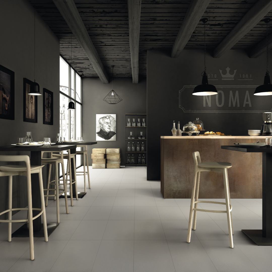 A modern cafe setting with charcoal black fixtures and Grey tiled flooring, the tile has soft stone appearance and texture. 