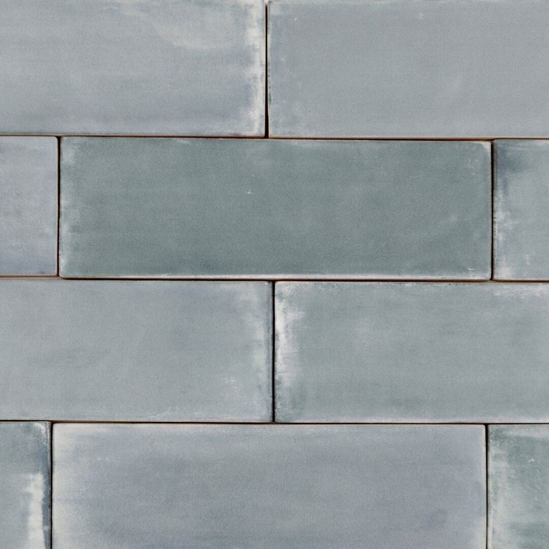Ariel view of a group of basalt gray blue green tiles in a brick layout to show the matte finish and colour variaiton. 