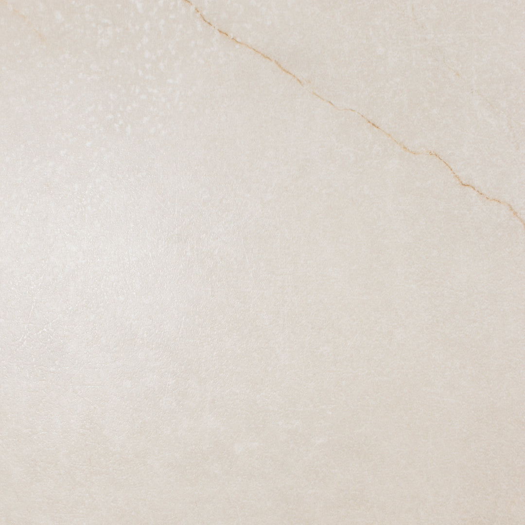 Ariel close up of a single 24x48 marble look cream warm white avorio tile with thin delicate gold veining and matte finish