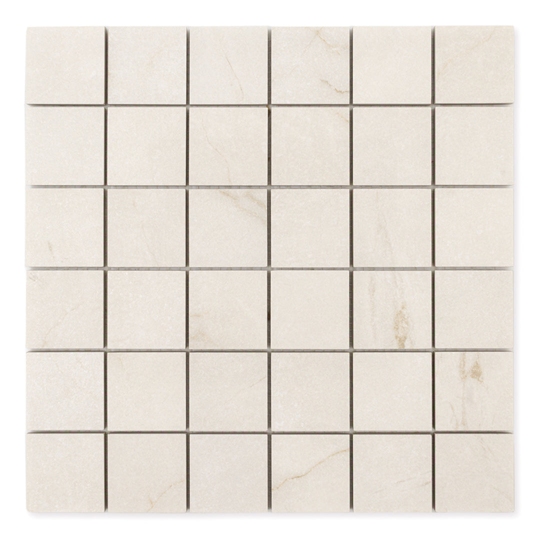 Ariel view of a 2x2 square sheet mosaic tile that is a cream avorio marble look with thin fine beige veining and matte finish