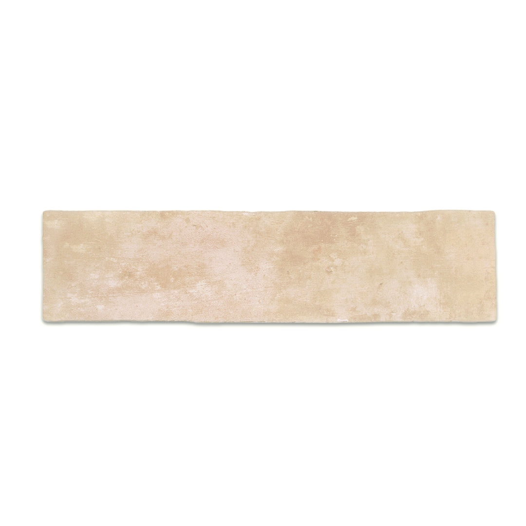 A single 11x2.75 brick clay sand beige stone look tile with a natural looking edge