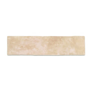 A single 11x2.75 brick clay sand beige stone look tile with a natural looking edge