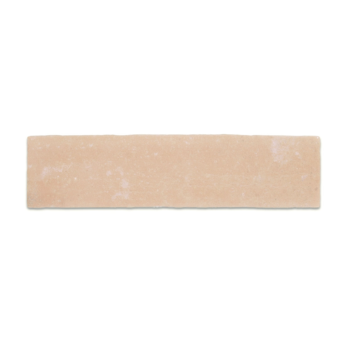 A single 11x2.75 brick clay orange toned sand beige stone look tile with a natural looking edge
