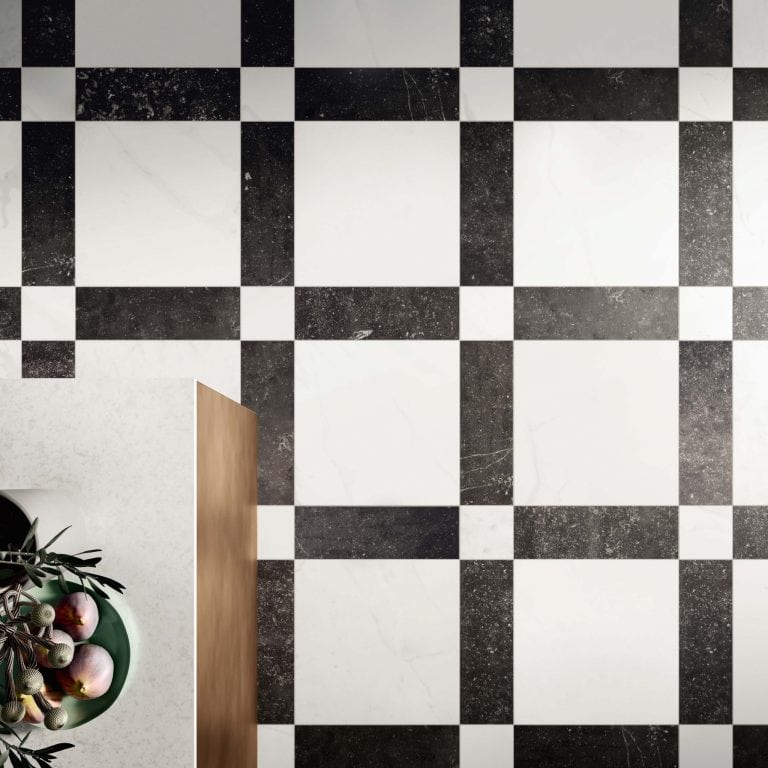 Ariel view of a black and white geometric pattern floor tile. There is white 16x16 stone look tiles surrounded by Black 5x16 stone look tiles with 5x5 white stone look tiles at the corners. 