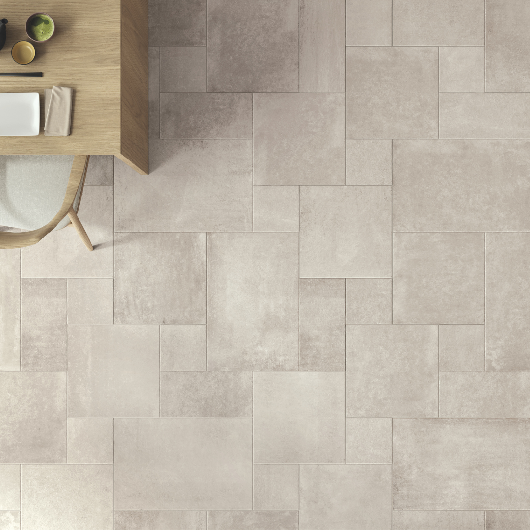 Ariel view of a light grey tumbled modular multi-format tile installed on a floor. 