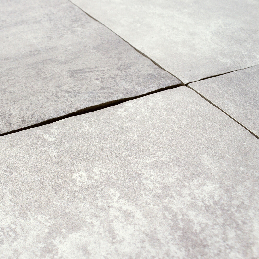 Angled close up of our cottage stone porcelain paver look multiformat tiles to show the texture, pattern, matte finish and colour. 