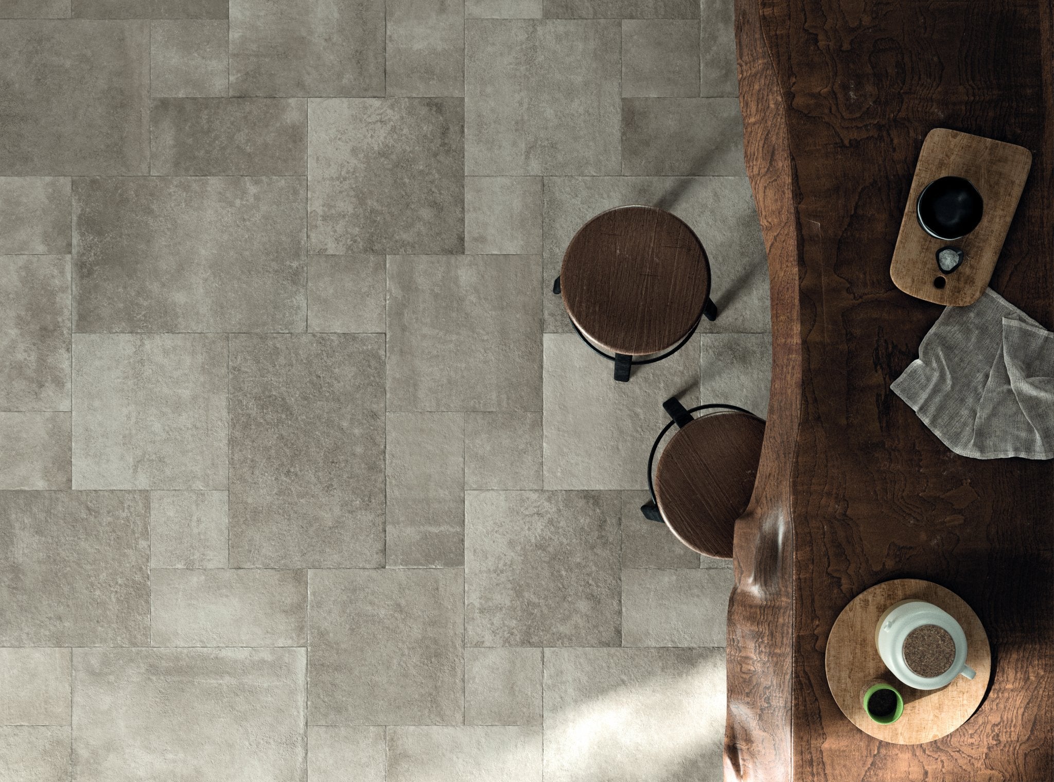 Ariel view of a multiformat porcelain tumbled paver look tile in a stone gray colour. 