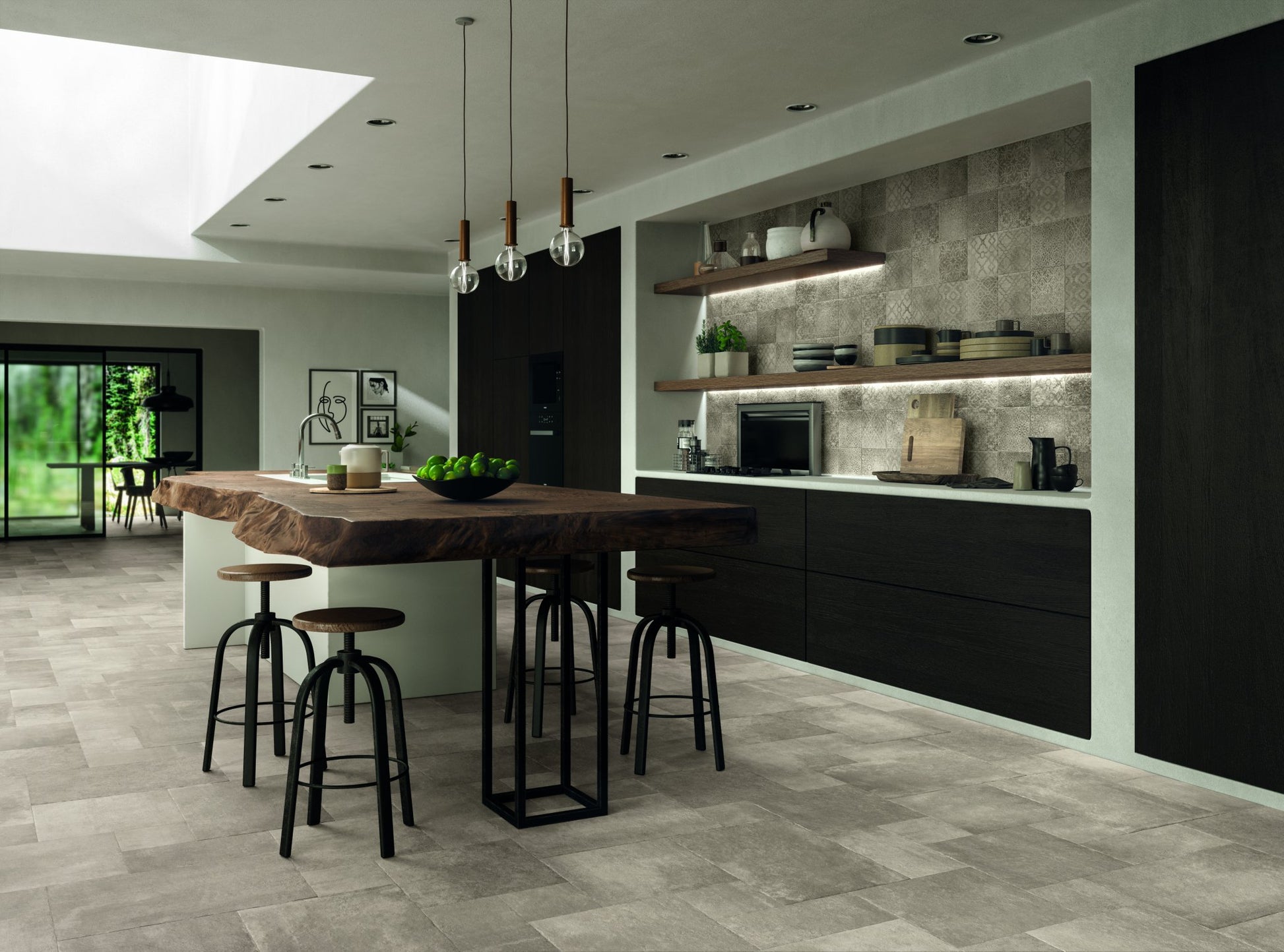 A modern interior designed kitchen with wood and black finishes. The tiled floor is cottage stone gray multiformat porcelain paver look tiles. The vibe is earthy and natural. 