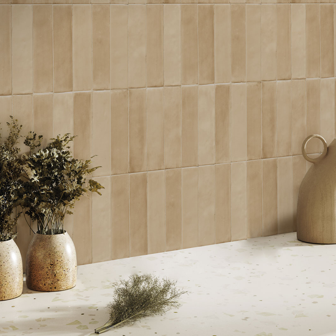 Modern vertical stack installation of a backsplash using Dolce Cream 2x9 matte subway tile in a soft beige shade with subtle texture and variated shades of colour. 