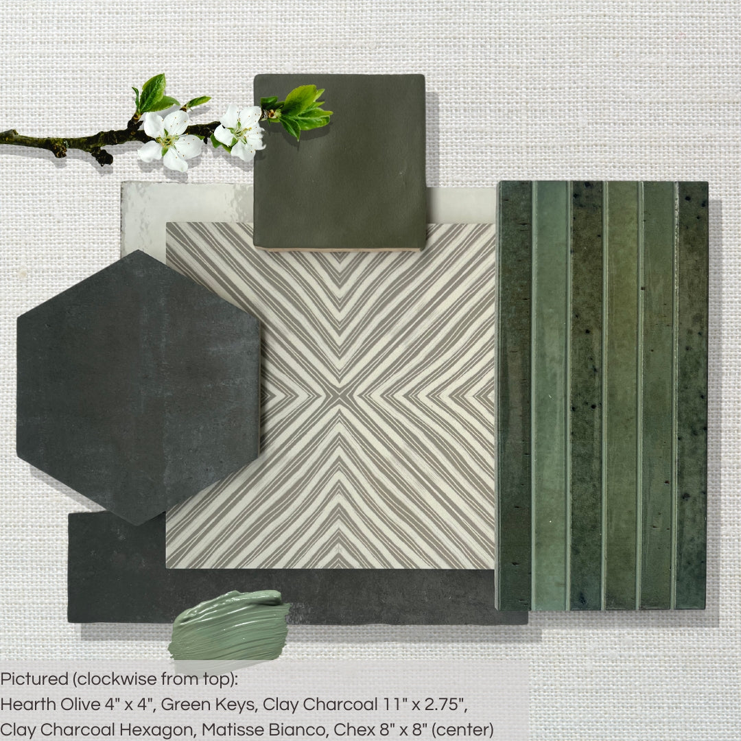 A flat lay of complimentary grey and green tiles including green keys fluted tiles, subway options and zellige, and a geometric pattern floor tile. 