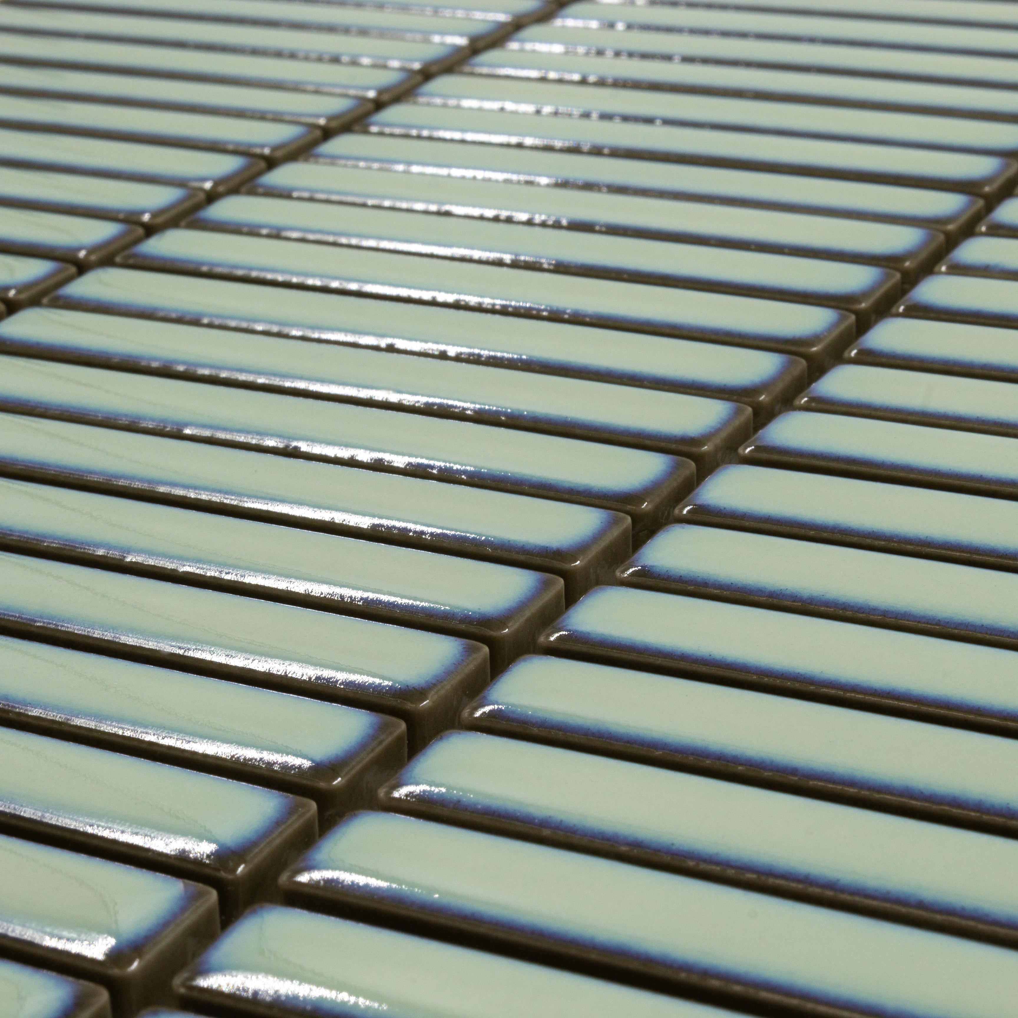 Angled close up view of a single sheet of mini kitkat stacked mosaic tiles in aqua green glossy. The sizing is 3/8' x 3-5/8" per tile, 10.5" X 12" per sheet