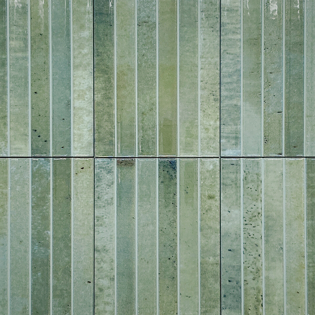 Ariel view of a group of 5x10 panel tile in glossy green, the tile has a 3D linear faux grout line kitkat look and colour variation. 