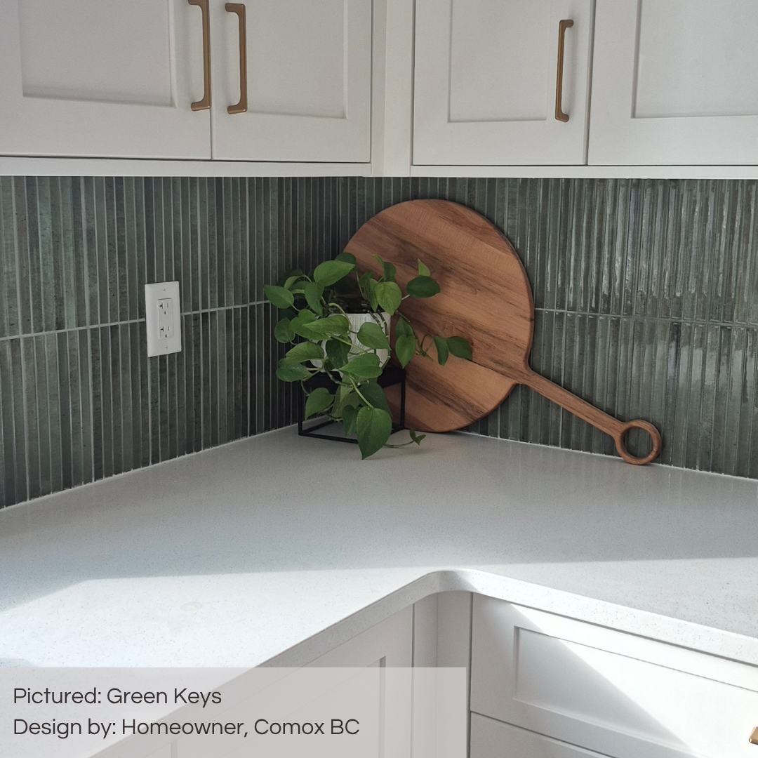 A bright white kitchen with a pop of colour backsplash using TilesInspired Green Keys glossy kitkat style tiles. 