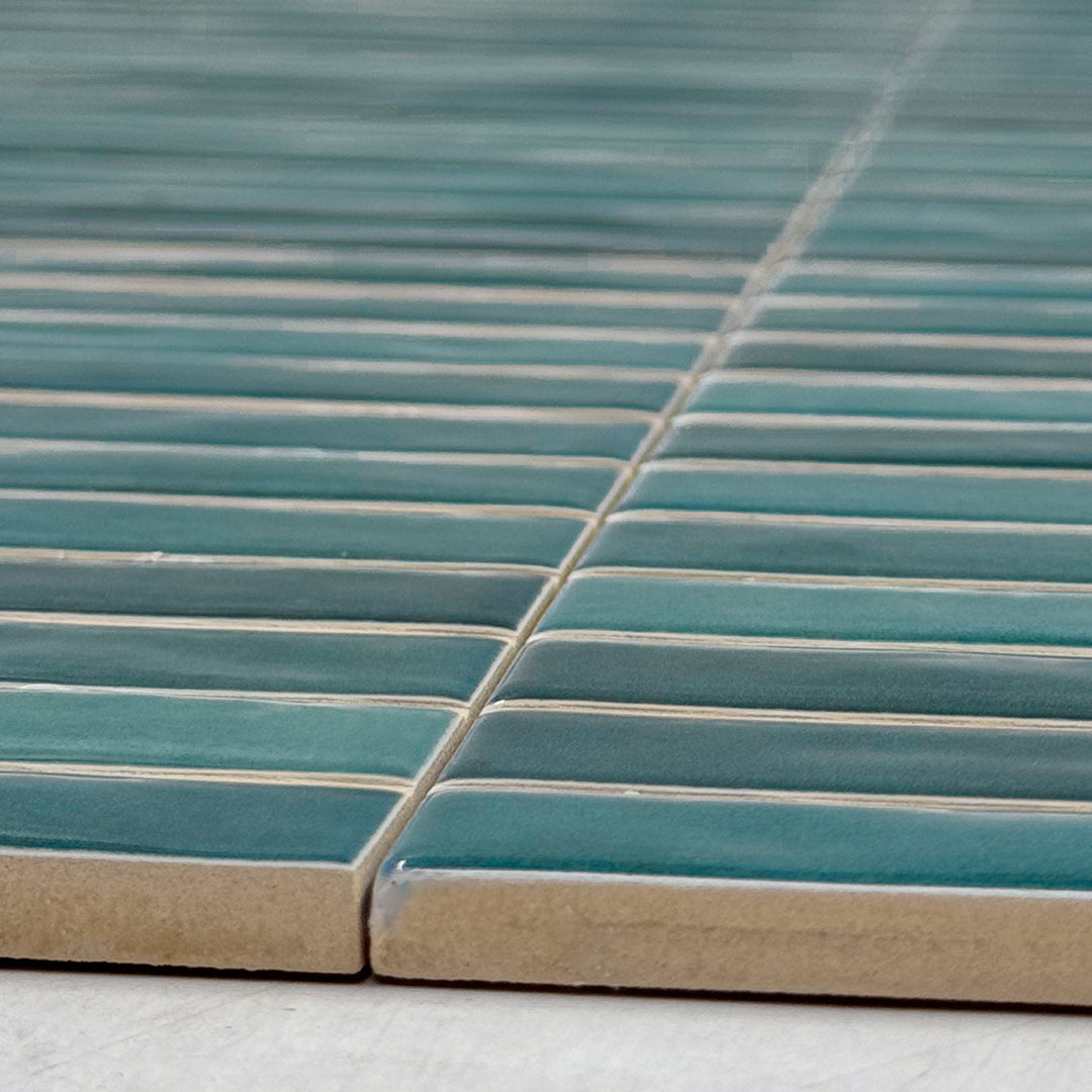 angled close up showing the subtle texture and edge of the tempo navy blue skinny kitkat tiles