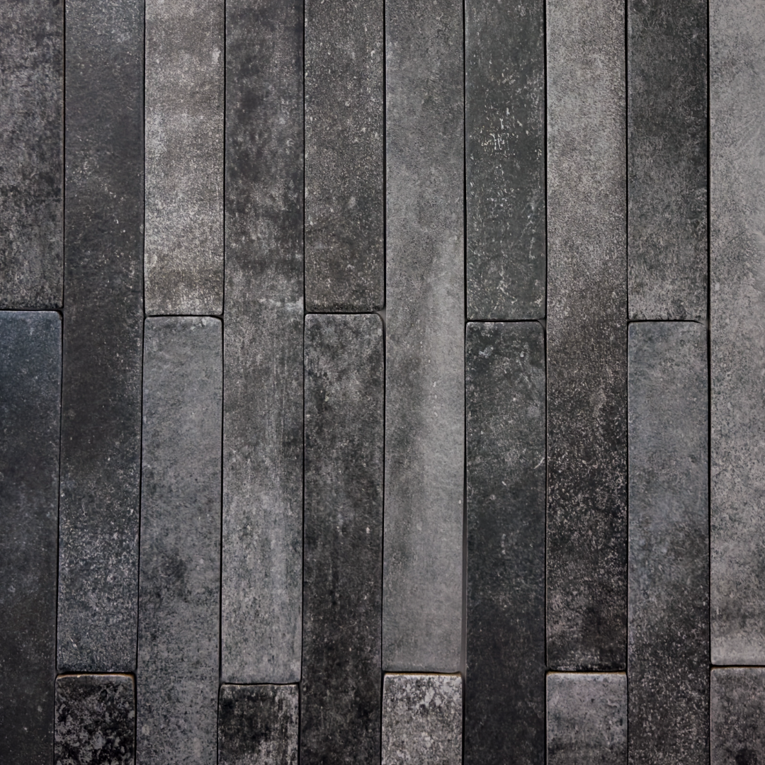 Ariel view of charcoal black 2x18 brick look tiles laid in a vertical brick pattern. Showing colour variance, texture and the finish. 