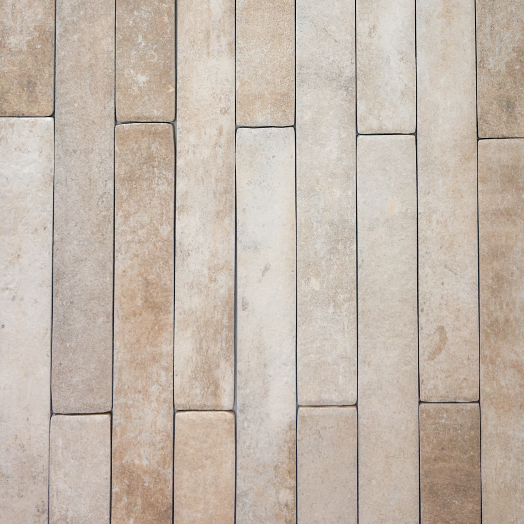 Ariel view of beige  2x18 brick look tiles in a vertical brick pattern. Showing the texture, colour variance and finish of the tiles.