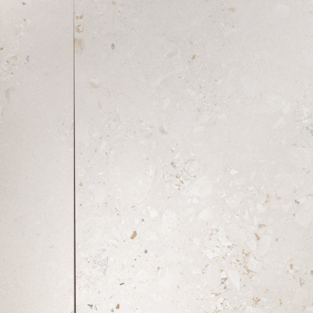 A side by side of two 36x36 cement terrazzo look tiles called oasis light they have a light stone base with light flecks. 