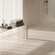 a close up of a modern bathroom and shower floor using oasis light cement terrazzo look tiles. 