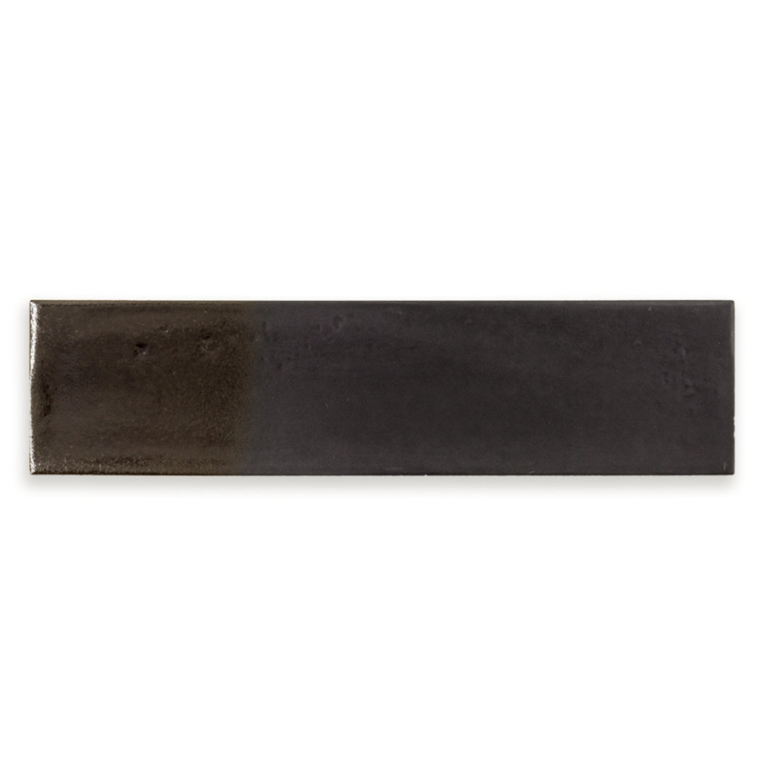 A single 3x12 glossy textured black tile.
